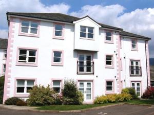a large white building with windows on a street at Skiddaw. 20 Greta Grove House in Keswick