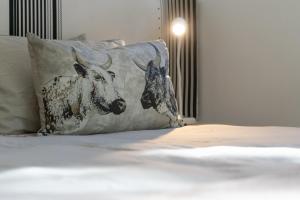 two cows on a pillow on a bed at Views over Wilderness in Wilderness