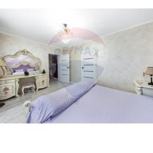 a bedroom with a large bed and a desk at RAX Panoramic House in Feleacu