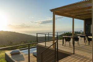 a balcony of a house with a view of the ocean at Views over Wilderness in Wilderness