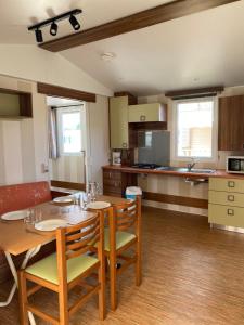 a kitchen and dining room with a table and chairs at Camping de Contrexeville in Contrexéville