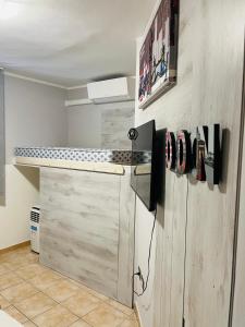 a kitchen with a counter and a refrigerator in a room at Homesweethome in Porto Torres
