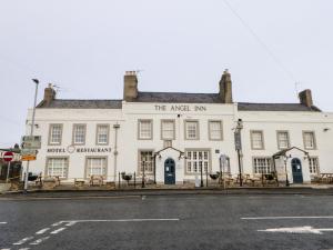 a white building on the corner of a street at Willows in Corbridge