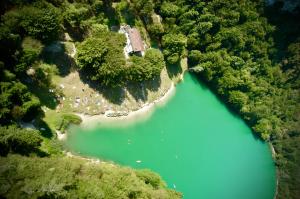 an aerial view of a lake in the woods at TerrazzaPaganella in Terlago