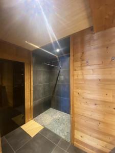 a bathroom with a shower with a wooden wall at Chalet de 6 chambres avec sauna terrasse amenagee et wifi a Font Romeu Odeillo Via a 1 km des pistes in Font Romeu Odeillo Via