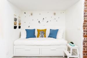 a bedroom with a white bed with butterflies on the wall at Rare! private garden in Paris, close to Sacre Coeur Basilica! in Paris