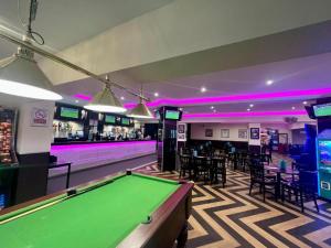 a pool table in a room with a bar at Sleeps 6 Gym Entertainment Pool Beach in Rhyl