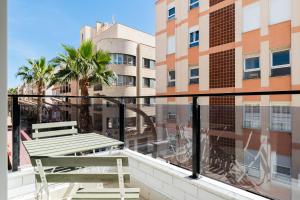 a balcony with a bench and a view of a building at Sunrise Center Suites in Torrevieja
