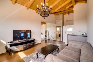 a living room with a couch and a table at Wine Residence Cattunar in Brtonigla