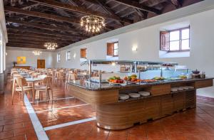 a restaurant with a buffet in the middle of a room at Hotel Macià Monasterio de los Basilios in Granada