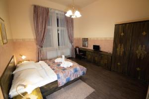 a hotel room with a bed and a window at Hotel Victor in Prague