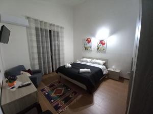 a small bedroom with a bed and a couch at Rosa's House Bed and Breakfast in Santa Margherita di Belice