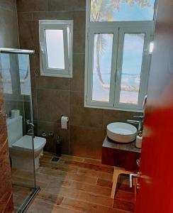 Efstratios Hotel في لوترا إديبسو: حمام مع مرحاض ومغسلة ونافذة