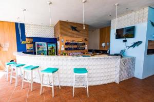 a bar with stools in front of a counter at FLAT PONTA NEGRA BEACH-Natal in Natal