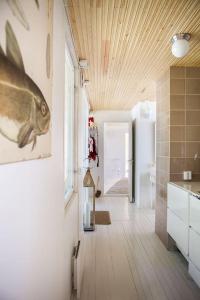 a kitchen with a fish painting on the wall at Villa Dyyni - South Facing - Seafront - Jacuzzi in Helsinki