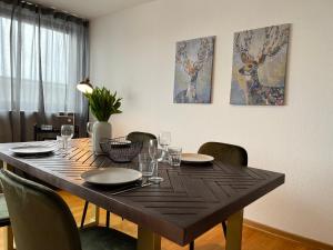 a dining room table with plates and glasses on it at My Place Holiday Appartments in Garding