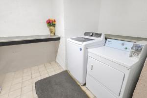 a white washer and dryer in a room at OYO Hotel Brownsville TN I-40 in Brownsville