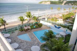 a view of the beach from the balcony of a resort at FLAT PONTA NEGRA BEACH-Natal in Natal