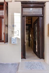 an open door to a building with a rug on the floor at Residenza di Veta in Rethymno Town