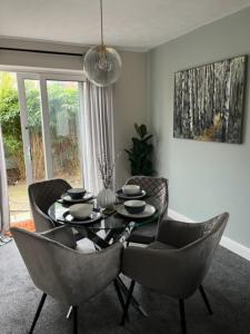 a dining room with a table and chairs at Modern cosy home sleeps 6 with parking nr Preston in Leyland
