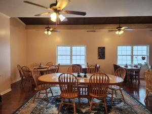 a dining room with tables and chairs and windows at Tybee Island Inn Bed & Breakfast in Tybee Island
