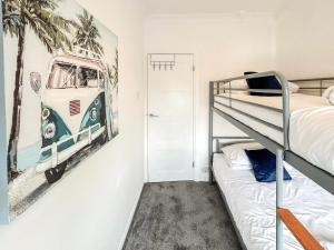 a bedroom with a bunk bed and a poster of a bus at Highcross in Poulton le Fylde