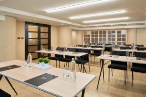 a large room with tables and chairs with bottles on them at Hotel Macià Cóndor in Granada