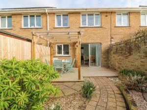 a house with a wooden deck in front of it at Home Waters in Weymouth