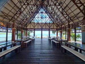 a building with benches and a view of the ocean at Sienna Resort in Maratua Atoll