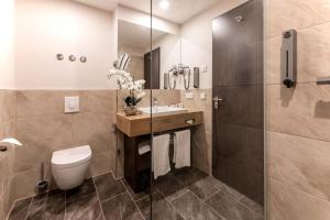 a bathroom with a toilet and a shower at PLAZA Premium Berlin Kurfürstendamm in Berlin +74 photos