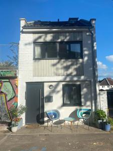 a building with three chairs and a building with graffiti at The Old Wire Factory in Bristol