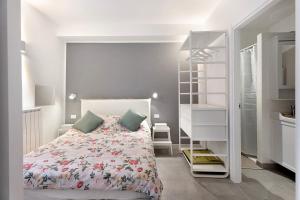 a white bedroom with a bed and a closet at Casa al lago in Nebbiuno