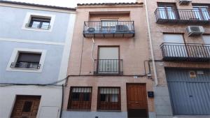an apartment building with a balcony and a door at La casa del Potro by Toledo AP in Toledo