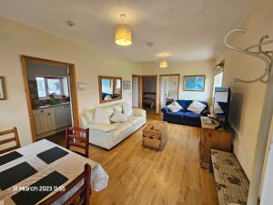 a living room with a couch and a table at Burnt House Farm in Highbridge