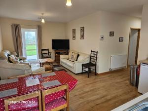 a living room with a couch and a table at Burnt House Farm in Highbridge