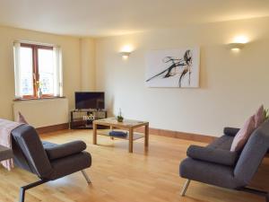 a living room with two chairs and a table at Sovereign House in Milford Haven