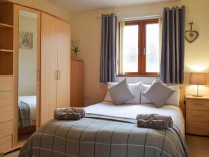 a bedroom with a bed and a window at Sovereign House in Milford Haven