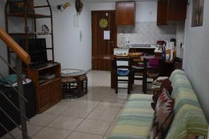 a living room with a couch and a kitchen at Marina Apartment 4 in Larnaca