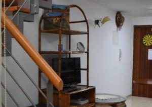 a living room with a tv and a staircase at Marina Apartment 4 in Larnaca