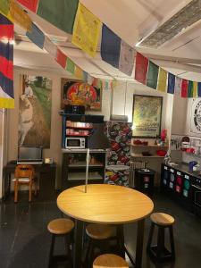 a table and stools in a room with flags at Santander Central Hostel in Santander