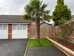 a palm tree in front of a garage at Inviting 1-Bed Studio in Manchester & feel at home in Manchester