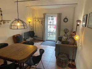 a living room with a table and a dining room at Op adem komen op de mooiste plek in het heuvelland-De Boswachter in Vijlen