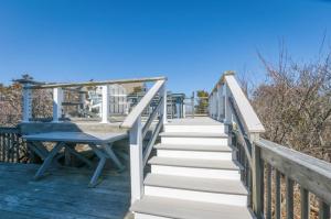 a stairway leading up to the beach with a blue table at 131 #5 North Shore Boulevard East Sandwich -- Waters Edge #5 in East Sandwich +16 photos