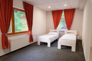 A bed or beds in a room at Penzión Michaela Vyhne