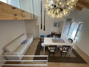 a living room with a couch and a table at La Piccola Casa al Lago - Intera casa con 3 camere e 2 box in Salò +62 photos