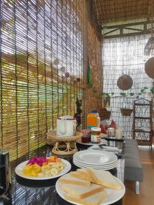 a table with plates of cheese and bread on it at Bloom Garden Bed & Breakfast in Siem Reap