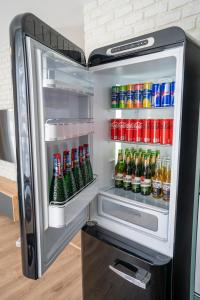 an open refrigerator filled with lots of drinks at Avocado apartment Victory port in Liptovský Mikuláš