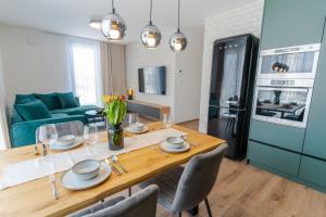 a kitchen and dining room with a table and chairs at Avocado apartment Victory port in Liptovský Mikuláš