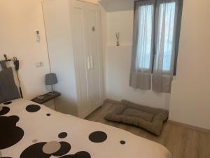 a bedroom with a bed and a window with a panda at COSY LITTLE HOME in Mergozzo
