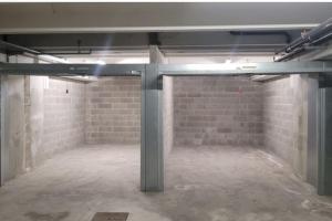 an empty room with a brick wall and a pole at La Piccola Casa al Lago - Intera casa con 3 camere e 2 box in Salò